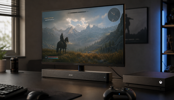 Gaming monitor connected to a soundbar and game console via HDMI on a clean desk setup