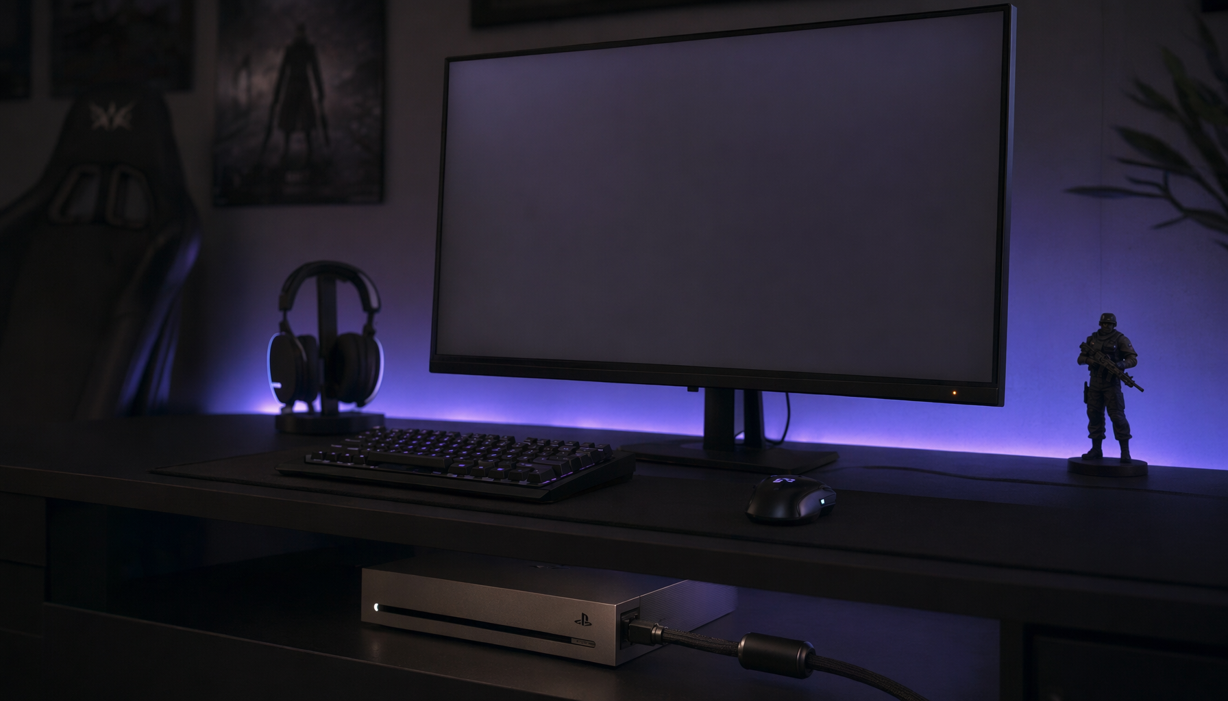 Gaming monitor waking from standby in a dark room while the console rests in the background